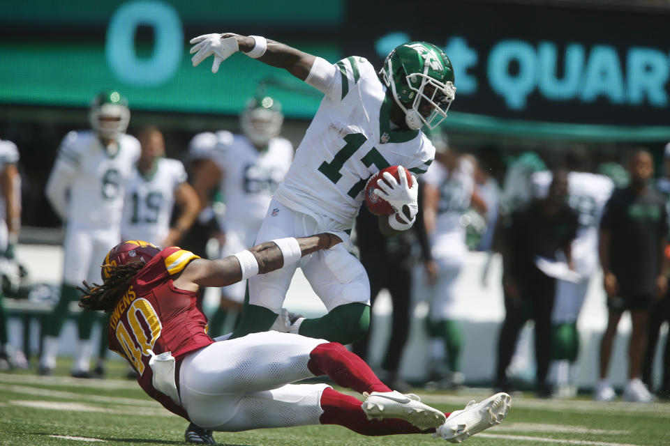 New York Jets' Malachi Corley (17) is stopped by Washington Commanders' Tyler Owens (40) on a punt return during the first half of an NFL preseason football game Saturday, Aug. 10, 2024, in East Rutherford. N.J. (AP Photo/John Munson)