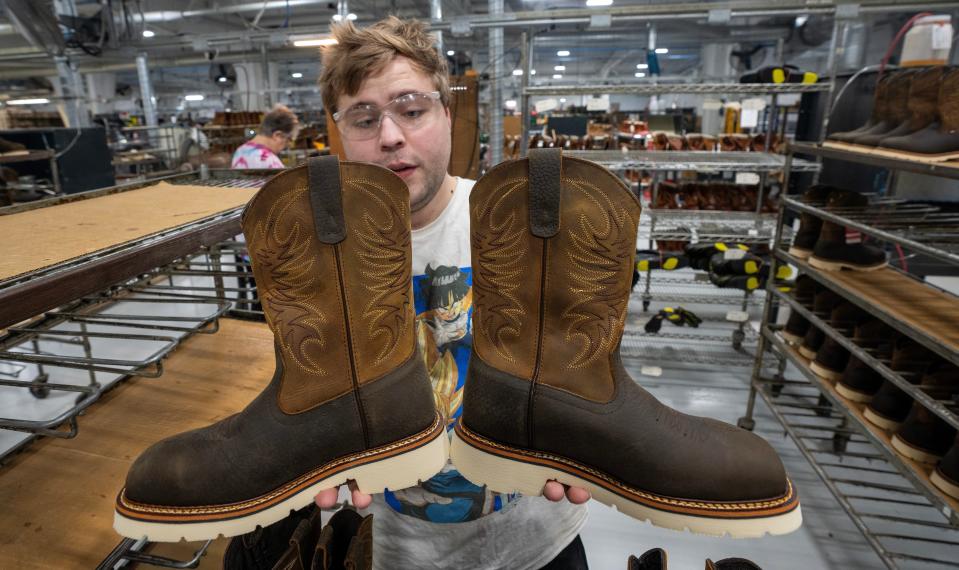 Devin Weidner inspects a pair of boots at the Weinbrenner Shoe Company in Merrill. It takes about 125 steps to make a typical boot. The company, which is one of the few American shoe companies remaining, was started in 1892. The employee-owned company is headquartered in Merrill.