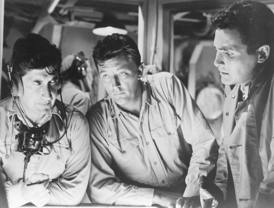 Actors David Post (L), Robert Mitchum (C), and David Hedison(R) in a submarine scene from the 1957 World War II film The Enemy Below. Post plays a sonar operator, Mitchum plays the role of Captain Murrell, and Hedison plays the role of Lt. Ware. (Photo by �� John Springer Collection/CORBIS/Corbis via Getty Images)