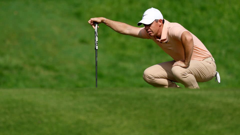 McIlroy lines up a putt during the tournament. - Ryan Kang/AP