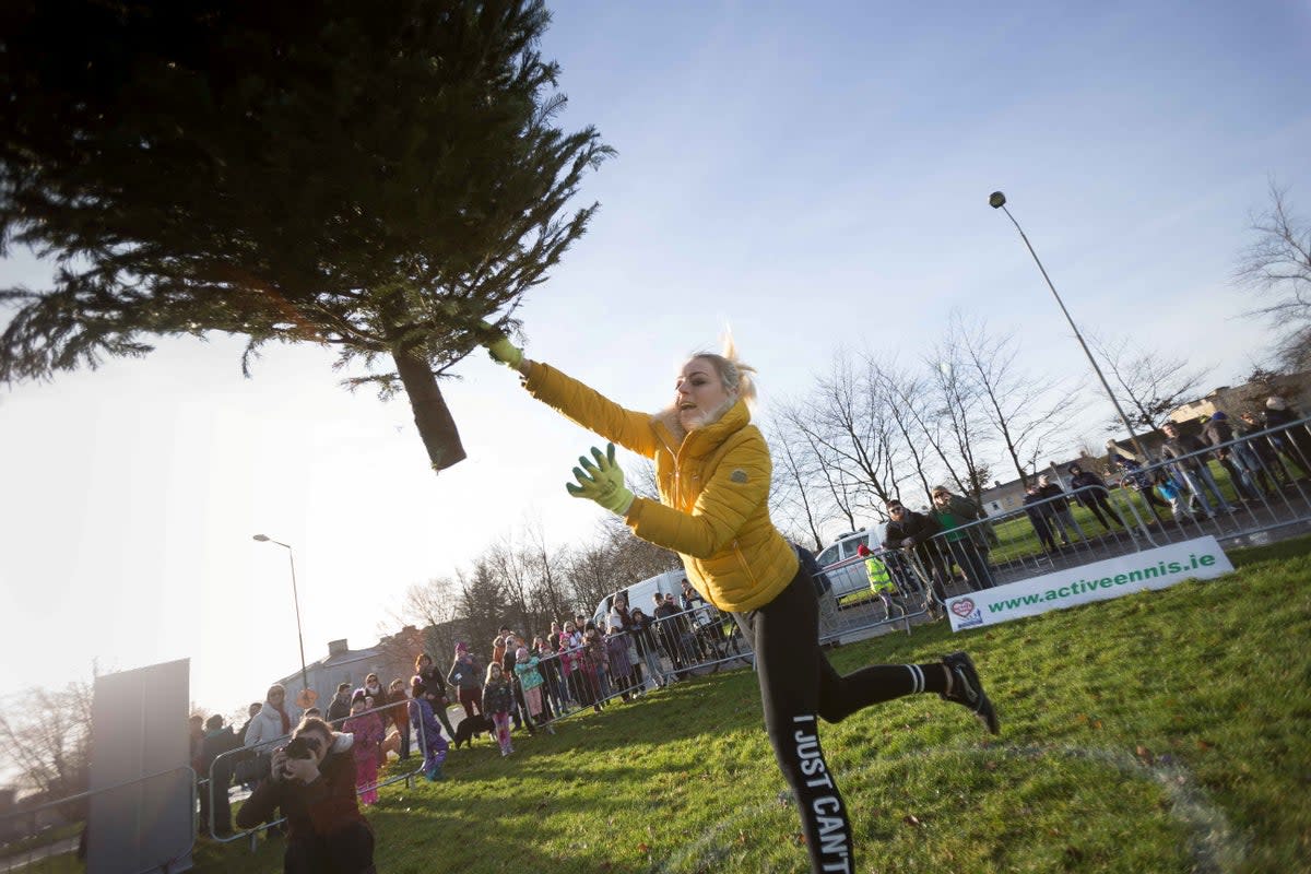 Kamila Grabska is seen as she wins the ladies section in the seventh annual Christmas Tree throwing Championships in Ennis, Co Clare, in 2018  (Eamon Ward/SWNS)