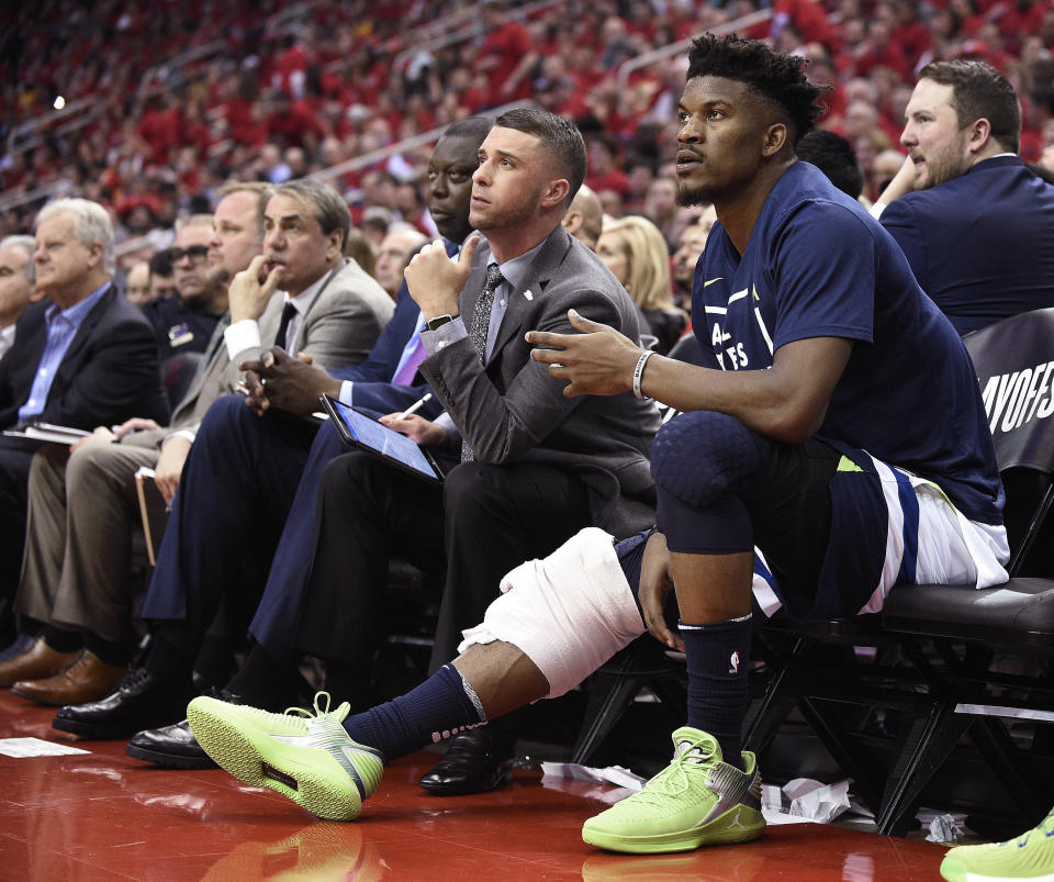 FILE - In this April 25, 2018, file photo, Minnesota Timberwolves guard Jimmy Butler, right, watches from the bench during the second half in Game 5 of the team's first-round NBA basketball playoff series against the Houston Rockets, in Houston. With Butler's status still unresolved, coach Tom Thibodeau and the Timberwolves head toward the season coming off the franchise’s first playoff appearance in 14 years but carrying yet a still-cloudy outlook despite the super-max contract Karl-Anthony Towns.(AP Photo/Eric Christian Smith, File)