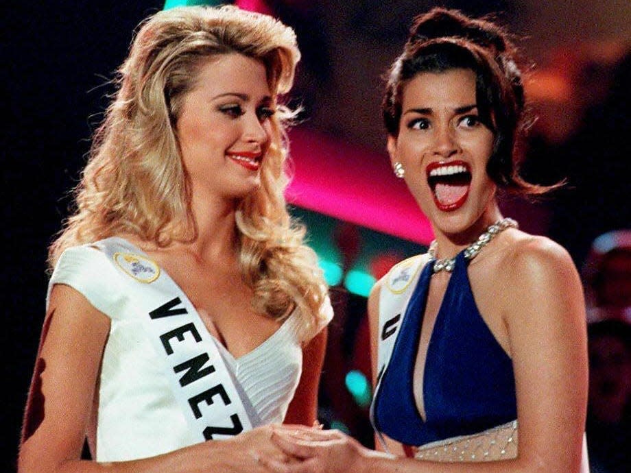 MAY 16: Brook Mahealani Lee of the US (R) reacts as she is announced the new 1997 Miss Universe Pageant winner as she holds hands with 1st runner up Marena Bencomo of Venezuela