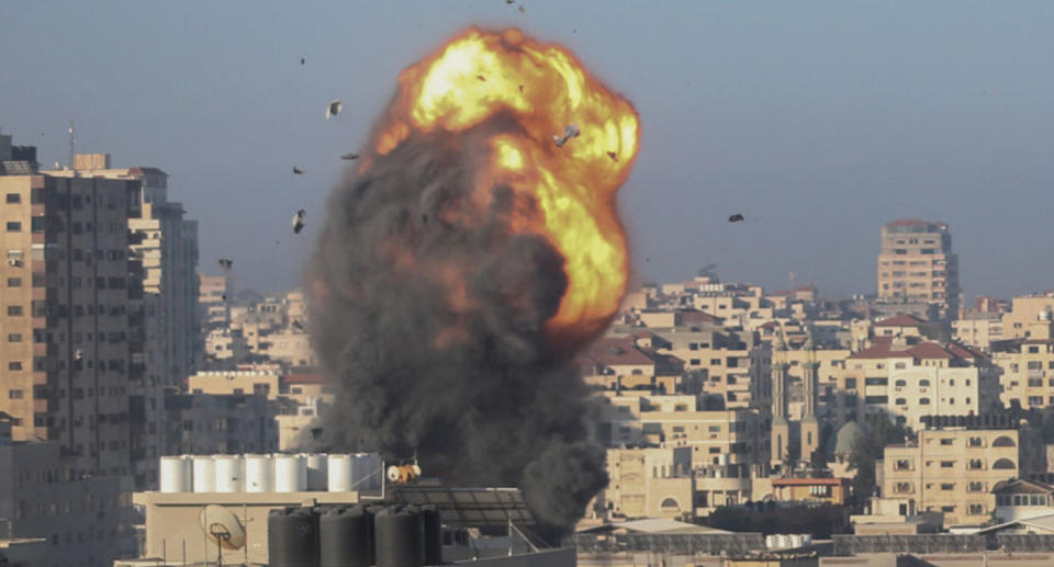 A fireball and smoke billow up into the air during an Israeli airstrike on Gaza City targeting the Ansar compound, linked to the Hamas movement, in the Gaza Strip early on May 15, 2021.