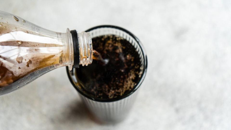 coca-cola cake recipe: soda bottle poured into glass birds eye view