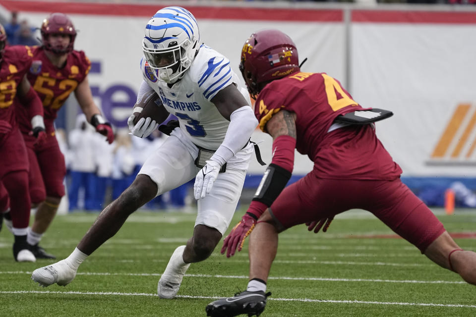 Memphis wide receiver Roc Taylor (3) runs the ball past Iowa State defensive back Jeremiah Cooper (4) during the first half of the Liberty Bowl NCAA college football game Friday, Dec. 29, 2023, in Memphis, Tenn. (AP Photo/George Walker IV)