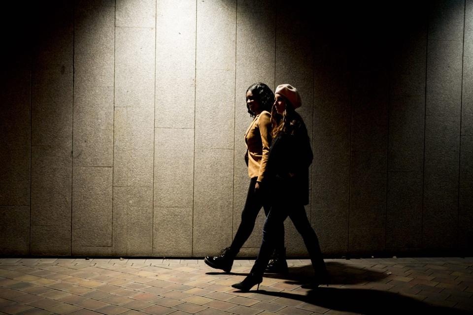 two women walking at night