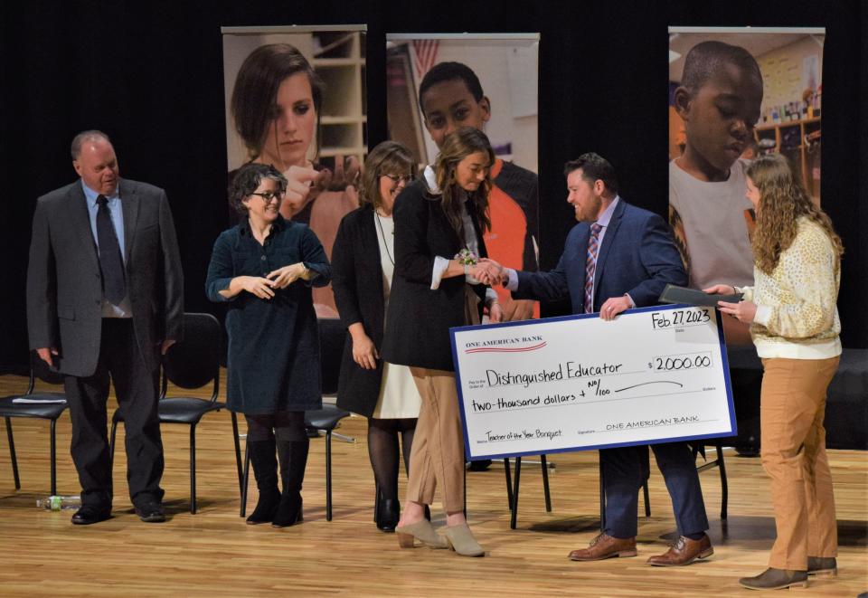 Laura Wiebelhaus (third from right) accepts a $2,000 check from One American Bank as part of her winnings for the Distinguished Educator award at a celebration for the 35th Annual Dr. John W. Harris Teacher of the Year on Feb. 27, 2023 at Ben Reifel Middle School. From left to right: board member Marc Murren, board president Kate Serenbetz, superintendent Jane Stavem, kindergarten teacher Laura Wiebelhaus, Dan Mueller from One American Bank and board vice president Carly Reiter.