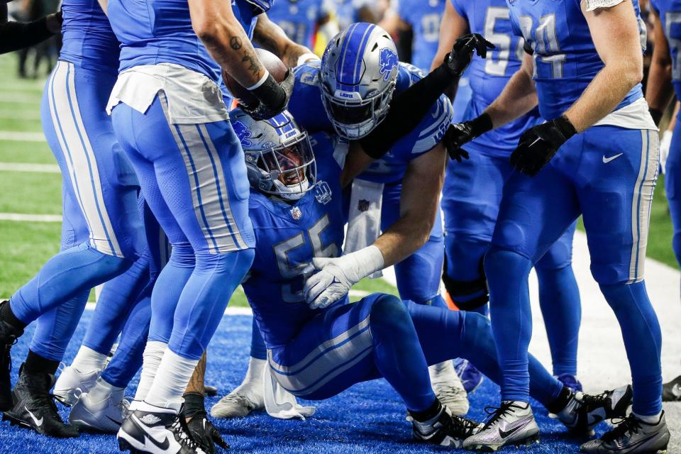 Detroit Lions players celebrate an interception made by linebacker Derrick Barnes (55) against Tampa Bay Buccaneers during the second half of the NFC divisional round at Ford Field in Detroit on Sunday, Jan. 21, 2024.