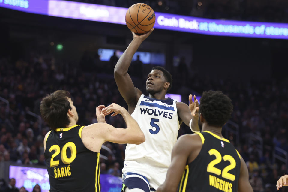 Minnesota Timberwolves guard Anthony Edwards (5) shoots against Golden State Warriors forward Dario Saric (20) and forward Andrew Wiggins (22) during the first half of an in-season NBA tournament basketball game in San Francisco, Tuesday, Nov. 14, 2023. (AP Photo/Jed Jacobsohn)