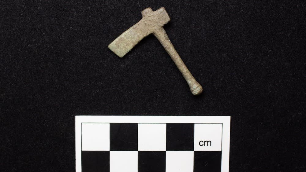  A miniature ax photographed on a black background. 