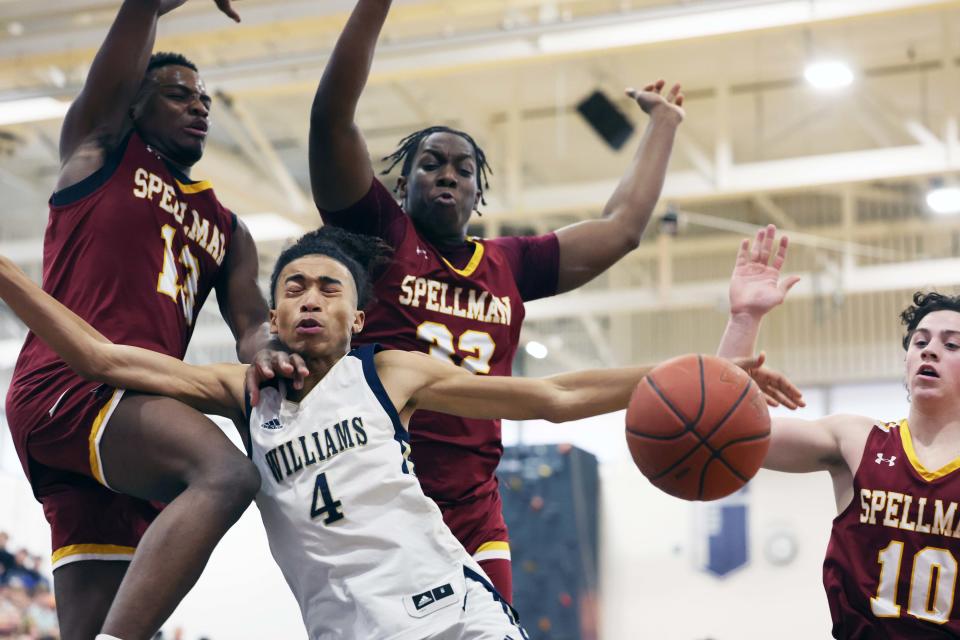 Archbishop Williams Julian Sustache is defended by Cardinal Spellman defenders from left, Jaydan Exalus, Marvin Petit-Frere and Matt O'Donnell during a game at Scituate High School on Wednesday, March 15, 2023.  