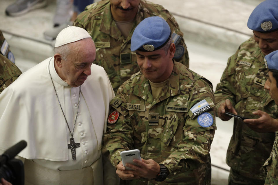 Pope Francis salutes a group of Argentine soldiers at the end of his weekly general audience at the Vatican, Wednesday, Jan. 8, 2020. (AP Photo/Gregorio Borgia)