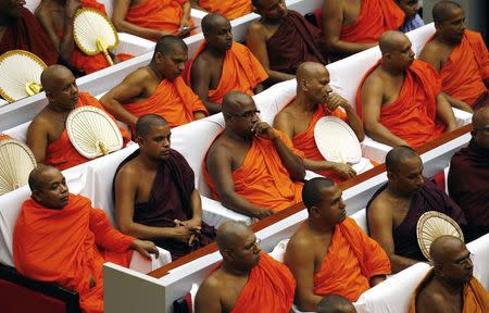 Buddhist monks listen as Pope Francis speaks during the Interreligious Encounter at the Bmich in Colombo January 13, 2015. REUTERS/ Stefano Rellandini