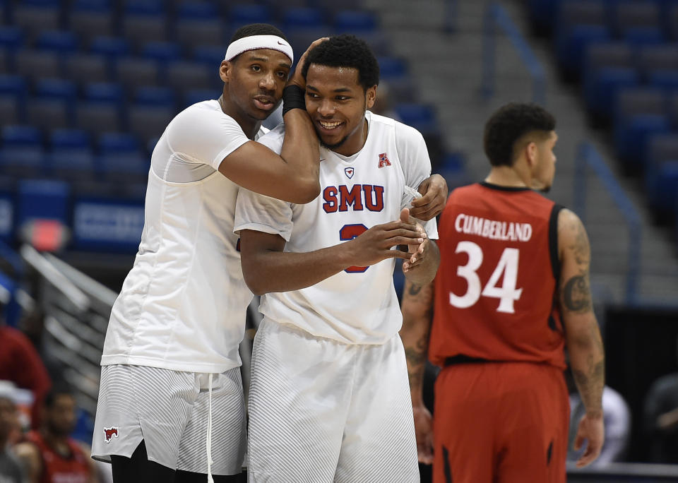 SMU's Jarrey Foster and Sterling Brown celebrate at the end of an NCAA college basketball game against Cincinnati in the American Athletic Conference tournament finals, Sunday, March 12, 2017, in Hartford, Conn. (AP Photo/Jessica Hill)