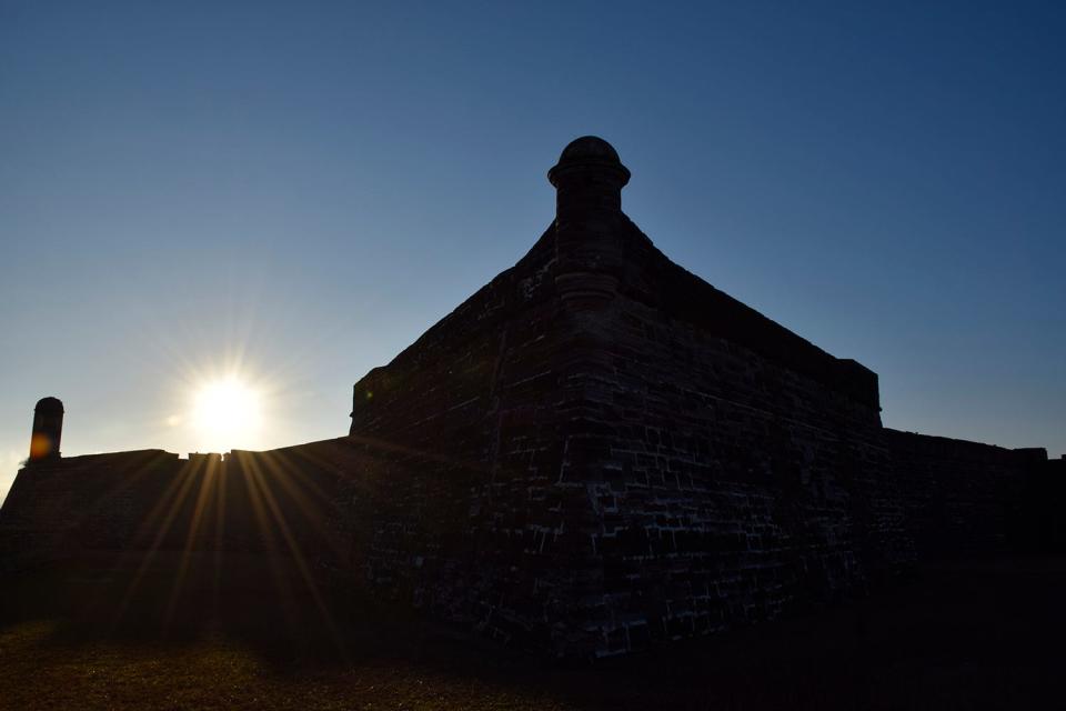 Sun rises over the top of the Castillo de San Marcos.