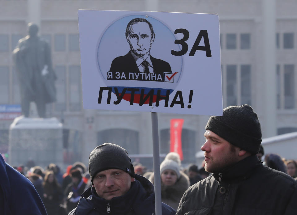 <p>People carry a placard reading, “We are for Putin!” as they walk after a rally to support Russian President Vladimir Putin in the upcoming presidential election at Luzhniki Stadium in Moscow, Russia, March 3, 2018. (Photo: Maxim Shemetov/Reuters) </p>