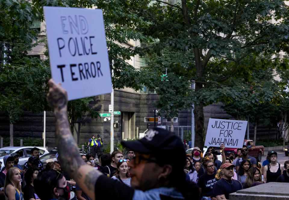 People gather to protest outside the Seattle Police Department's West Precinct after body camera footage was released of a Seattle police officer joking about the death of Jaahnavi Kandula, a 23-year-old woman hit and killed in January by officer Kevin Dave in a police cruiser, Thursday, Sept. 14, 2023, in Seattle. (AP Photo/Lindsey Wasson)