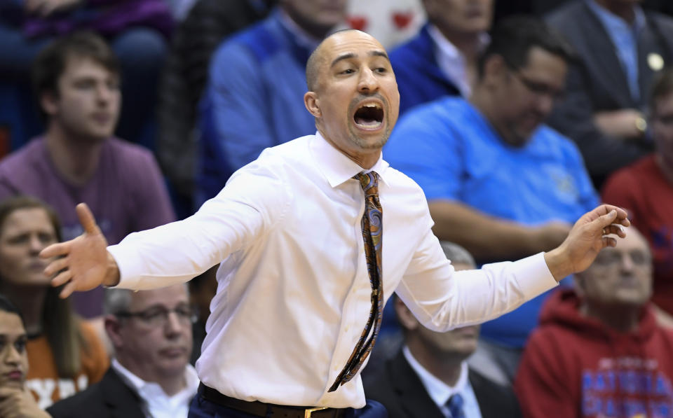 Texas head coach Shaka Smart yells to his team during the first half of their NCAA college basketball game against Kansas in Lawrence, Kan., Monday, Feb. 3, 2020. (AP Photo/Reed Hoffmann)