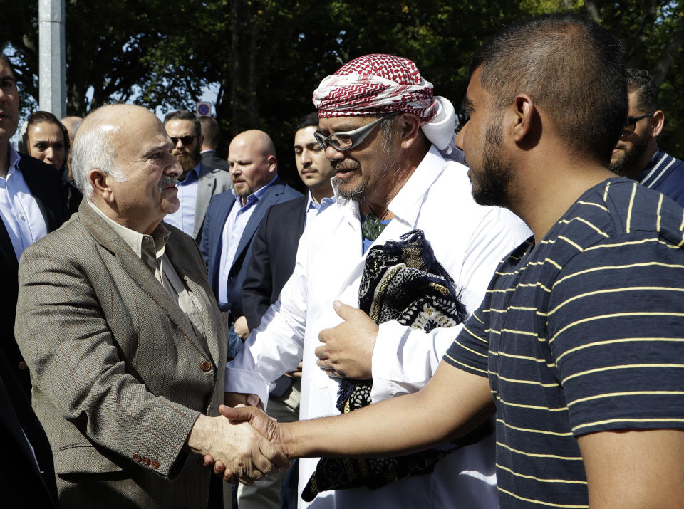 His Royal Highness Prince El Hassan bin Talal Hashemite, left, of the Kingdom of Jordan greets worshippers outside the Al Noor mosque in Christchurch, New Zealand, Saturday, March 23, 2019. The mosque reopened today following the March 15 mass shooting. (AP Photo/Mark Baker)