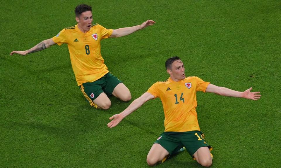 Connor Roberts celebrates with Harry Wilson after scoring Wales’s second goal, deep in added time