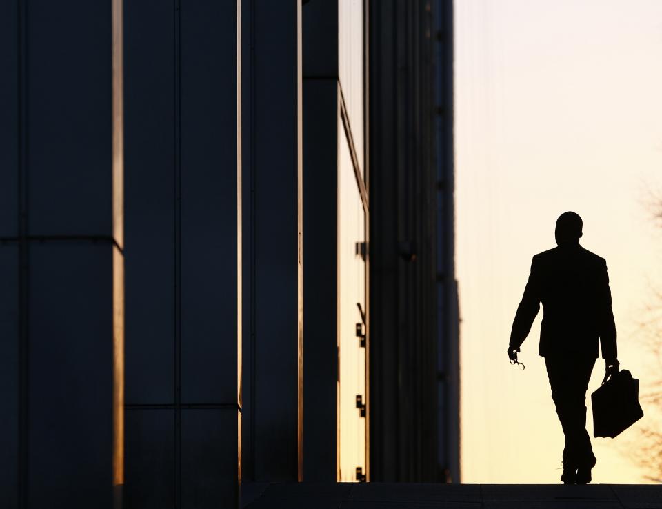 A worker arrives at his office in the Canary Wharf business district in London February 26, 2014. London's financial services sector created 25 percent more jobs in February than a year ago, new data has shown, indicating the industry may be recovering from the restructuring and redundancies prompted by the financial crisis. After a strong January, the City hiring market showed no signs of slowing down last month, with 3,220 new jobs created, compared with 2,575 added in February 2013, according to financial services recruiter Astbury Marsden. The data suggests London's banks and financial services companies are returning to growth after slashing thousands of jobs in the face of a lengthy recession and a series of industry scandals that followed the financial crisis. Picture taken February 26, 2014. REUTERS/Eddie Keogh (BRITAIN - Tags: BUSINESS EMPLOYMENT TPX IMAGES OF THE DAY)  ATTENTION EDITORS: PICTURE 03 OF 25 FOR PACKAGE 'CITY OF LONDON - LIFE IN THE SQUARE MILE'. TO FIND ALL IMAGES SEARCH 'RECRUITER KEOGH'