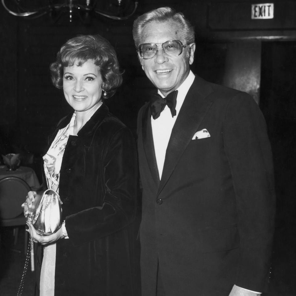 American actor Betty White stands smiling with her husband, TV producer and host Allen Ludden