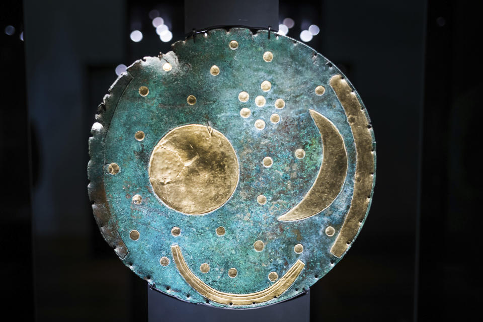 In this Sept. 20, 2018 photo the so-called Sky Disc of Nebra, made of bronze and gold, from 1,600 BC. is displayed at an archeological exhibition at the Martin-Gropius-Bau museum in Berlin. The new exhibition showcasing more than 1,000 major archaeological finds from the past 20 years shows reveals how Germany has been at the heart of European trade, migration, conflict and innovation since the Stone Age. The exhibition runs from Sept. 21, 2018 until Jan. 6, 2019. (AP Photo/Markus Schreiber)