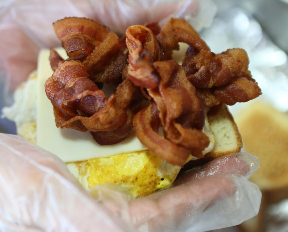 A bacon, egg and cheese sandwich being prepared for a customer at Helen's Sausage House near Smyrna.