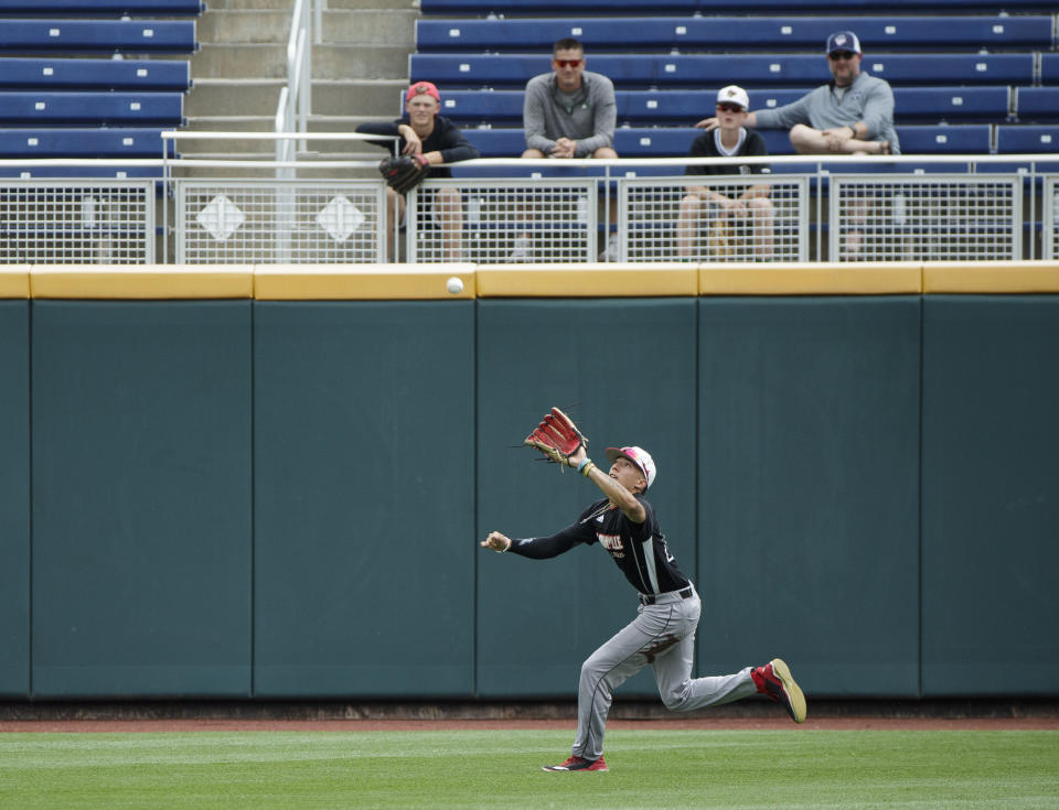 Louisville's Trey Leonard catches a fly ball during practice for baseball's College World Series at TD Ameritrade Park, Friday, June 14, 2019, in Omaha, Neb. (Ryan Soderlin/Omaha World-Herald via AP)