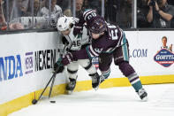 Los Angeles Kings center Blake Lizotte (46) and Anaheim Ducks defenseman Jackson LaCombe (60) battle for the puck during the second period of an NHL hockey game Tuesday, April 9, 2024, in Anaheim, Calif. (AP Photo/William Liang)