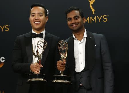 Alan Yang (L) and Aziz Ansari pose backstage with their awards for Outstanding Writing For A Comedy Series for "Master Of None" at the 68th Primetime Emmy Awards in Los Angeles, California U.S., September 18, 2016. REUTERS/Mario Anzuoni