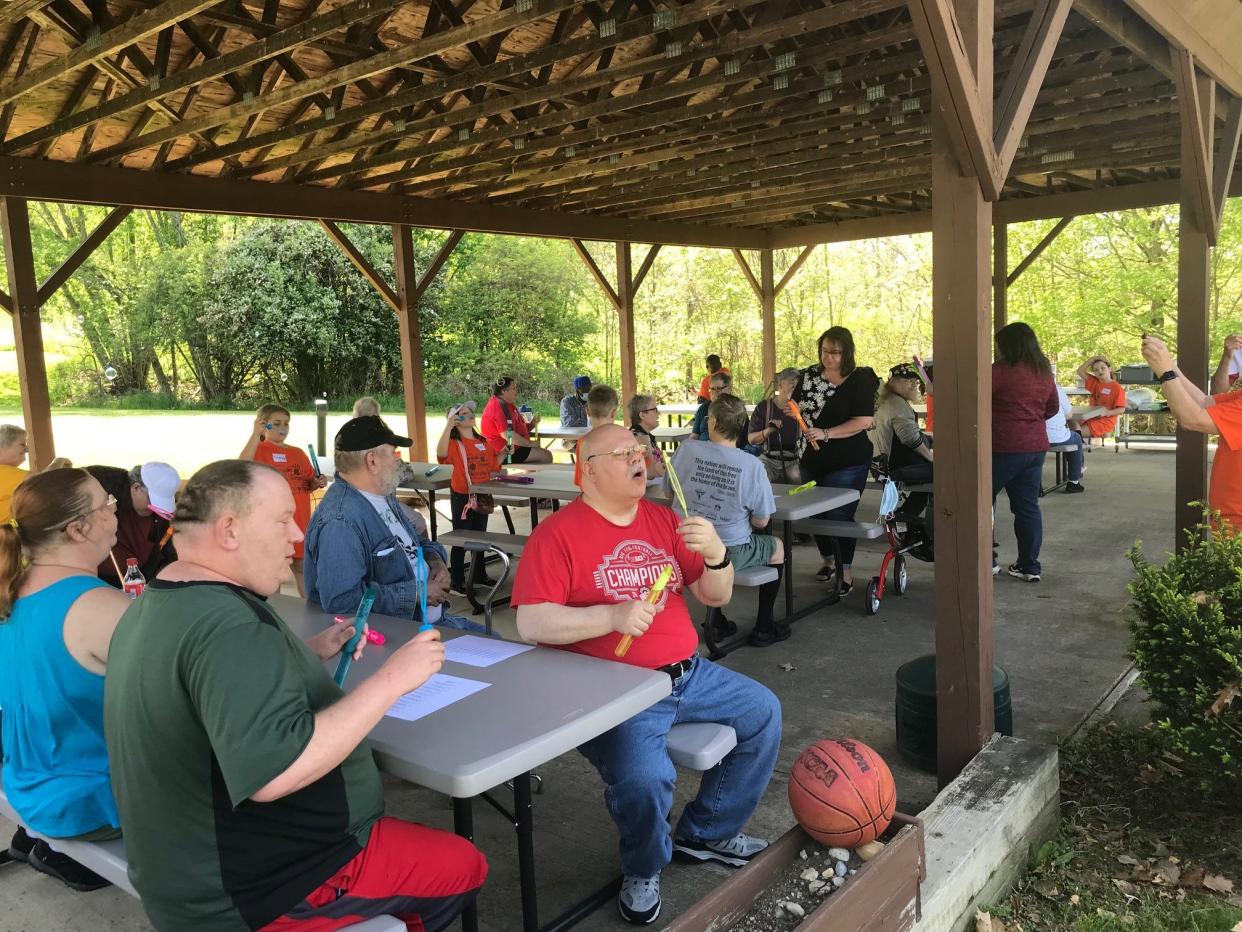 Residents of Dayspring on Olivesburg Road Friday celebrated with residents at the annual spring picnic, this year sponsored by Doc Stumbo and Sherman School. Residents and third graders took time to blow bubbles before the cookout.