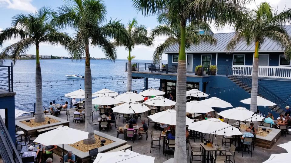 Village Brewhouse in Fishermen's Village offers courtyard seating with umbrella-covered tables overlooking Charlotte Harbor.