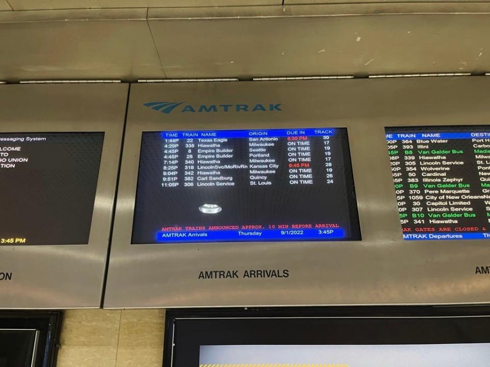 screen showing train times at an amtrak train station