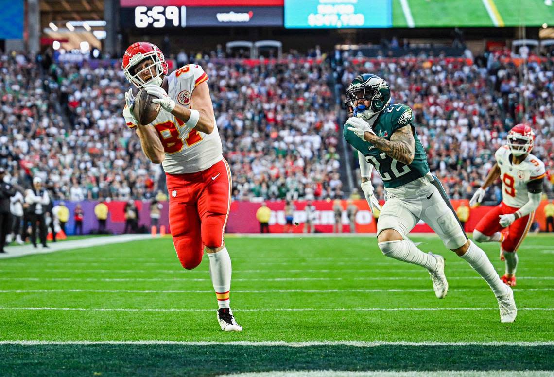 Kansas City Chiefs tight end Travis Kelce makes a catch for a touchdown in the first quarter past the defense of Philadelphia Eagles safety Marcus Epps during Super Bowl LVII Sunday, Feb. 12, 2023, in Glendale, Ariz.