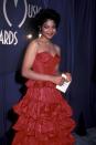 <p> Before Janet Jackson was selling out stadiums and creating groundbreaking music, she was a child star with a very famous family. In 1983 she attended the American Music Awards at just 17 years old. She wore a prom-inspired red strapless tiered gown and accessorised with a gold key on a hoop earring. </p>