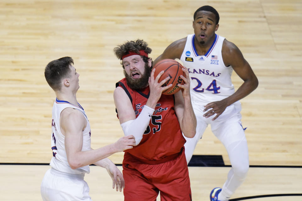 Eastern Washington forward Tanner Groves (35) is pressured by Kansas guard Christian Braun, left, and Kansas guard Bryce Thompson (24) as he goes up for a shot during the second half of a first-round game in the NCAA college basketball tournament at Farmers Coliseum in Indianapolis, Saturday, March 20, 2021. (AP Photo/AJ Mast)