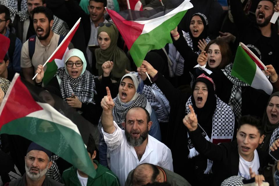 Protesters chant slogans while holding Palestinian flags during a protest to show their solidarity with the Palestinians, outside the Byzantine-era Hagia Sophia mosque in Istanbul, Turkey, in Istanbul, Turkey, Saturday, Oct. 14, 2023.(AP Photo/Khalil Hamra)