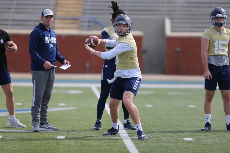 Georgia Southern offensive coordinator/quarterbacks coach Bryan Ellis, left, watches as quarterback Kyle Vantrease (6) completes passing drills during practice.