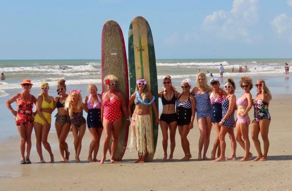 Competitors dress in 1950s and ‘60s garb during the vintage portion of the 20th Waterman’s Challenge on Cocoa Beach in 2021.