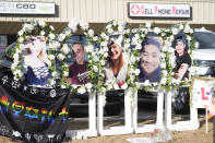 Photographs of the victims of a mass shooting at a gay nightclub stand a part of a makeshift memorial near the club Wednesday, Nov. 23, 2022, in Colorado Springs, Colo. The alleged shooter facing possible hate crime charges in the fatal shooting of five people at a Colorado Springs gay nightclub is scheduled to make their first court appearance Wednesday from jail after being released from the hospital a day earlier. (AP Photo/David Zalubowski)