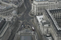 A view over the City of London looking at the Bank of England, right, from the 59th floor of 22 Bishopsgate in London, Thursday, April 1, 2021. When the pandemic struck, about 540,000 workers vanished from London's financial hub almost overnight. The area known as "the City" became a ghost town as many people began working from home. A year on, most haven't returned to the business hub. While many people believe that post-pandemic workflow will become the new normal, skyscrapers are still rising, and city planners say they aren't worried about empty office blocks. (AP Photo/Alastair Grant)