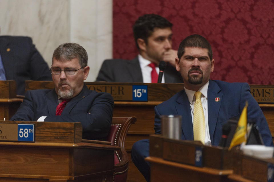 Majority Leader Daryl Cowles, R - Morgan, left, and staffer James Fuerhoff are seen during a special session of the state House of Delegates in Charleston, W.V., on Monday, Aug. 13, 2018. The delegates are voting on 15 articles of impeachment charges against Supreme Court Chief Justice Margaret Workman and Justices Robin Davis, Allen Loughry and Beth Walker. (Craig Hudson/Charleston Gazette-Mail via AP)