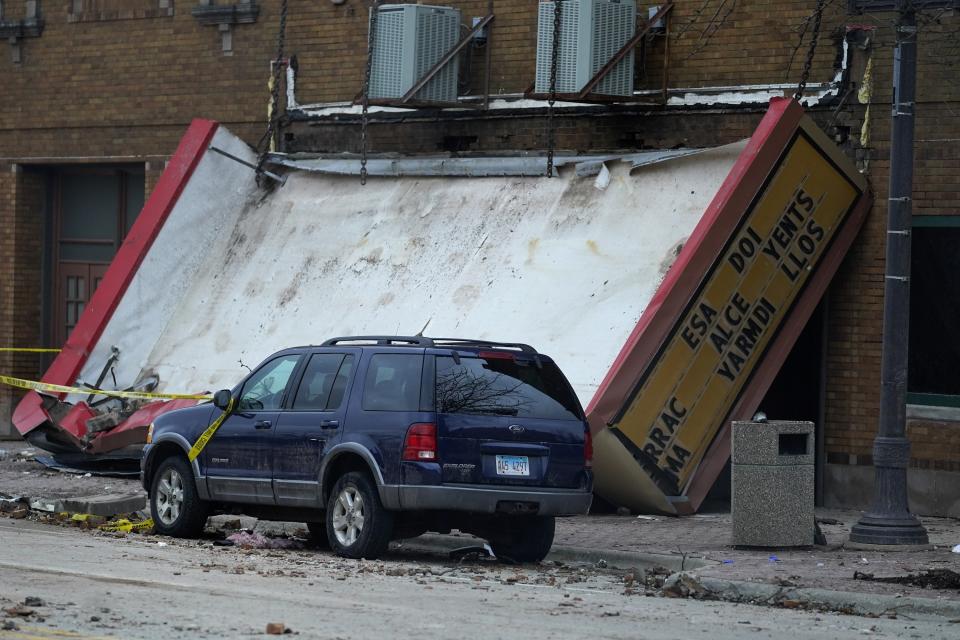 The marquee of the Apollo Theatre is down at the scene where the roof of the theatre collapsed during a tornado Friday evening, Saturday, April 1, 2023, in Belvidere, Ill. Belvidere Fire Chief Shawn Schadle said 260 people were in the venue for a concert. (AP Photo/Erin Hooley)