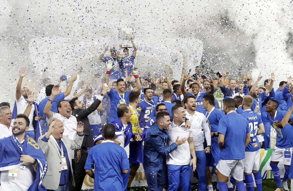 In this Oct. 17, 2018 photo, Cruzeiro players lift the Brazil Cup as they celebrate their victory and crowning themselves champions after defeating Corinthians in the final soccer match, in Sao Paulo, Brazil. (AP Photo/Andre Penner)