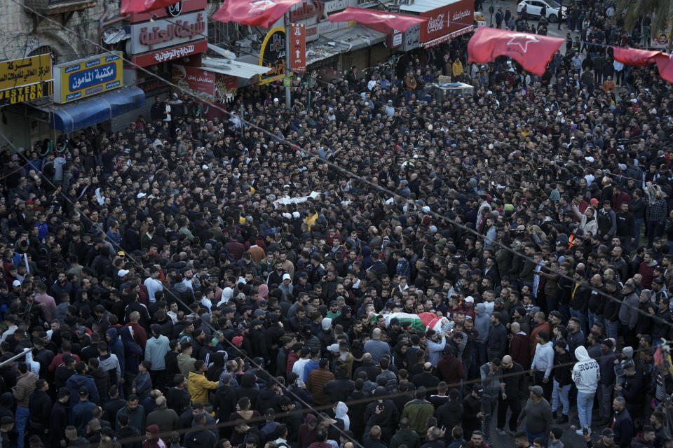 Palestinians carry the bodies of 10 men killed in clashes with Israel troops in the West Bank city of Nablus, Wednesday, Feb. 22, 2023. Palestinian officials say that at least 10 Palestinians have been killed and 102 were wounded during a rare daytime Israeli army arrest raid in the occupied West Bank. The Palestinian Health Ministry says a 72-year-old man was among the dead. (AP Photo/Majdi Mohammed)