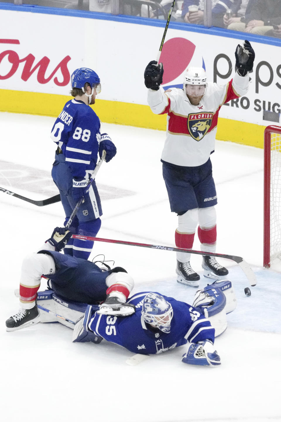Florida Panthers' Sam Bennett (9) celebrates a goal by teammate Brandon Montour, not shown, as Toronto Maple Leafs goaltender Ilya Samsonov (35) and teammate William Nylander (88) look on during the third period of Game 1 of an NHL hockey Stanley Cup second-round playoff series in Toronto, Tuesday, May 2, 2023. (Chris Young/The Canadian Press via AP)