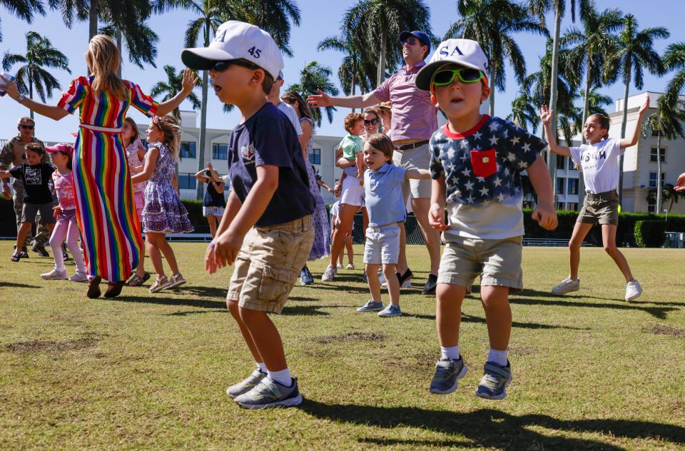 Asbury Bean, 4, and his younger brother Augustine, 2, do jumping jacks during Saturday's event.