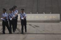 Policemen patrol near the entrance of the Jinan Intermediate People's Court where the trial of disgraced Chinese politician Bo Xilai will be held, in Jinan, Shandong province September 22, 2013. A Chinese court will announce its verdict on former top politician Bo on Sunday following his 5-day trial last month on charges of corruption and abuse of power. He could be handed a long jail term by the Communist Party-controlled court. REUTERS/Aly Song (CHINA - Tags: POLITICS CRIME LAW)